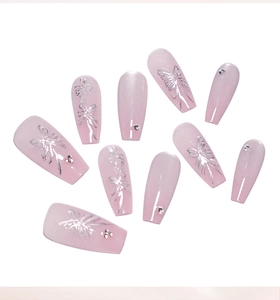 Detail of pink cat eye coffin nails featuring silver butterfly motifs and small rhinestones