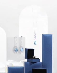 Detail of dark blue leatherette jewelry boxes with black velvet lining on white blocks