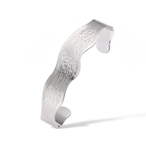Detailed view of silver wave cuff bracelet with textured hammered metal finish