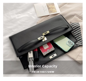 Top view of black minimalist handbag showing spacious interior with luxury daily essentials