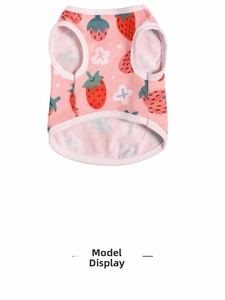 Close-up of pink pet vest with strawberry print and soft cotton material texture