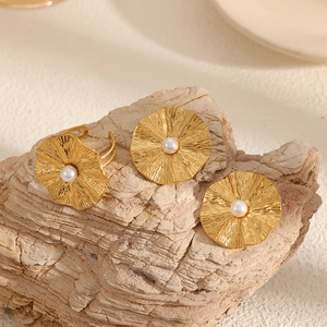 Artistic gold flower and pearl jewelry set with earrings and open ring on stone