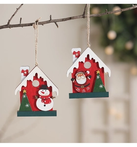 Detail of wooden Christmas house ornaments with HO HO HO text hanging on a tree branch