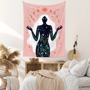 Detail of pink bohemian tapestry with celestial sun, moon phases and floral art