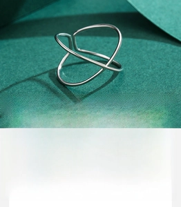 Close-up of polished S925 sterling silver X-shape minimalist cross ring details
