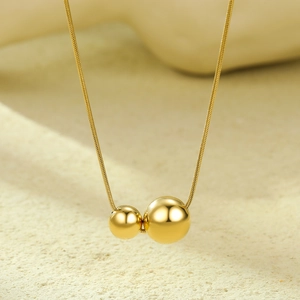 Minimalist gold stainless steel necklace with double hollow sphere pendants on snake chain