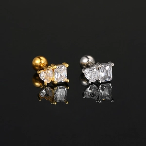 Detailed close-up of gold and silver geometric stud earrings with square and heart zircons