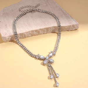 Detail of silver double-layered tassel necklace with zircon butterfly and teardrop charms