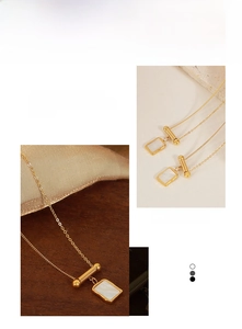 Detail shot of the irregular square pendant with white shell inlay on a gold titanium chain