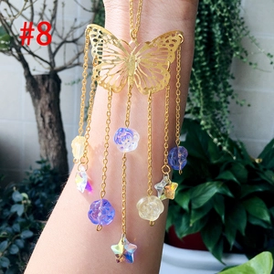 Detailed close-up of golden butterfly suncatcher with colorful floral beads and stars