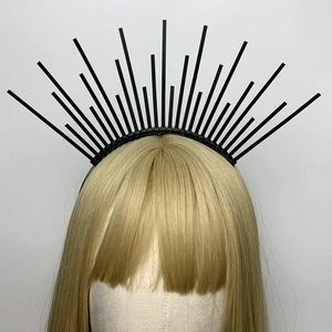 Detail of a black spiked halo crown headband on a blonde model with a zipper design