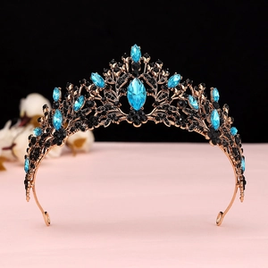 Close-up of rose gold tiara with black rhinestones and royal blue marquise crystals