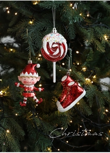 Detail of red and white glittery Christmas ornaments hanging on a festive tree