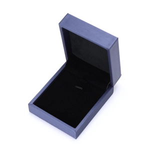 Detail of dark blue brushed texture jewelry gift box with premium black velvet interior