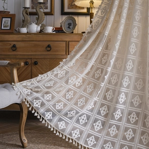 Beige crochet lace curtain with geometric hollow patterns and fringe tassels for decor