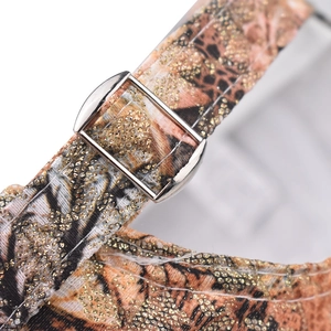Macro detail of leopard print strap with shiny gold glitter and silver metal buckle