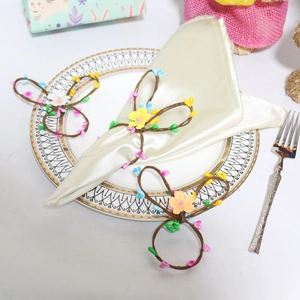 Handmade Easter rabbit twig napkin rings with colorful berries and small yellow flowers