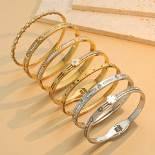 Detail view of pearl bangles with gold wire wrapping and decorative zircon accents