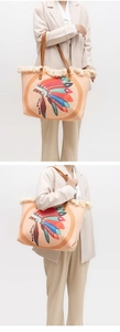 Detail of bohemian fringe tote bag with colorful feather patterns and woven texture