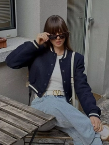 Women's navy blue short baseball jacket with striped sleeves and ribbed knit collar