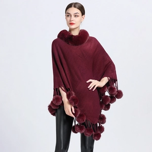 Elegant wine red knit poncho with faux rabbit fur collar and playful pom-pom fringe