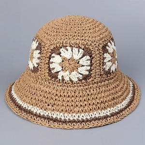 Close-up of handmade crochet straw hat showing intricate flower patterns and textures