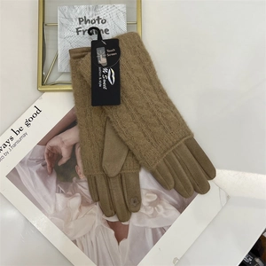 Detail of camel knit touchscreen gloves featuring classic cable texture and floral sensor