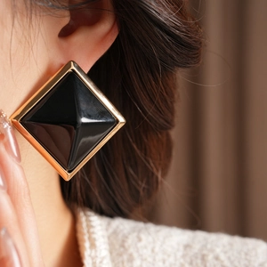 Elegant geometric square stud earrings with golden frames and black pyramid resin inserts