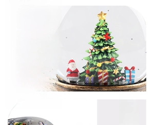 Close-up of Santa Claus and Christmas tree inside a festive snow globe with bronze base