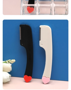 Detail of mini eyebrow razors with heart patterns against pink and blue backdrop
