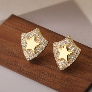 Exquisite gold-plated shield stud earrings with zircon stars on dark wood base