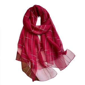 Red silk wool blend scarf with thin white pinstripes and soft drape on white background