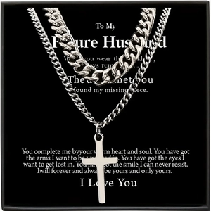 Close-up of double-layer silver Cuban chain and cross pendant in a black gift box