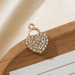 Macro shot of gold heart pendant with micro-paved zircons on a wooden display