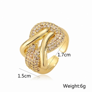Detailed view of the 1.5cm high irregular intertwined gold ring with zircon pavé