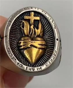 Detail of Sacred Heart of Jesus ring featuring cross and thorn motifs in two-tone finish