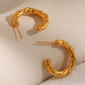 Detailed close-up of 18K gold plated hoop earrings with irregular hammered texture surface