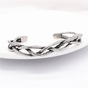 Close-up of vintage braided titanium steel eagle cuff bracelet with scaled texture detail