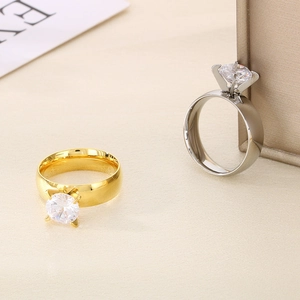 Close-up of 6mm polished gold and silver stainless steel rings with zircon stones