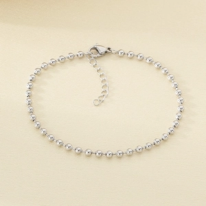 Detail of silver beaded stainless steel bracelet with lobster clasp and adjustable chain