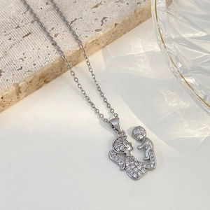 Silver mother and child hug pendant necklace with white zircons on marble background