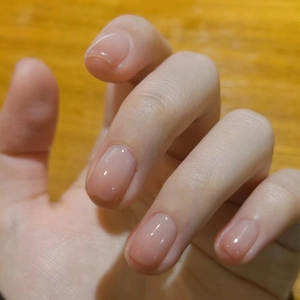 Cat eye blush gradient press-on nails with a natural glossy finish on hands