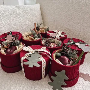 Christmas knit gift box with apple, pine cones, and festive DIY decorations