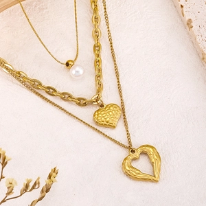 Three-layer gold titanium steel necklace featuring pearls and layered heart pendants