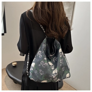 Detail of gothic nylon crossbody bag with skull flower print and LOVE letter strap