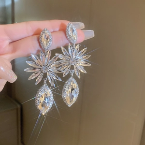 Close-up of sparkling floral drop earrings with marquise crystals and brilliant shine