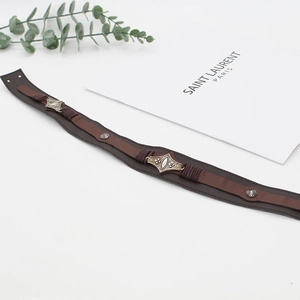 Close-up of brown leather hat band with vintage bohemian metal pieces and studs