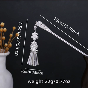 Silver ethnic hair pin with hollow flower and tassel details shown with dimensions