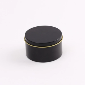 Matte black cylindrical candle tin with elegant gold rim accent on white background