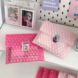 Close-up detail of heart-shaped bubble wrap packaging with pink shockproof texture